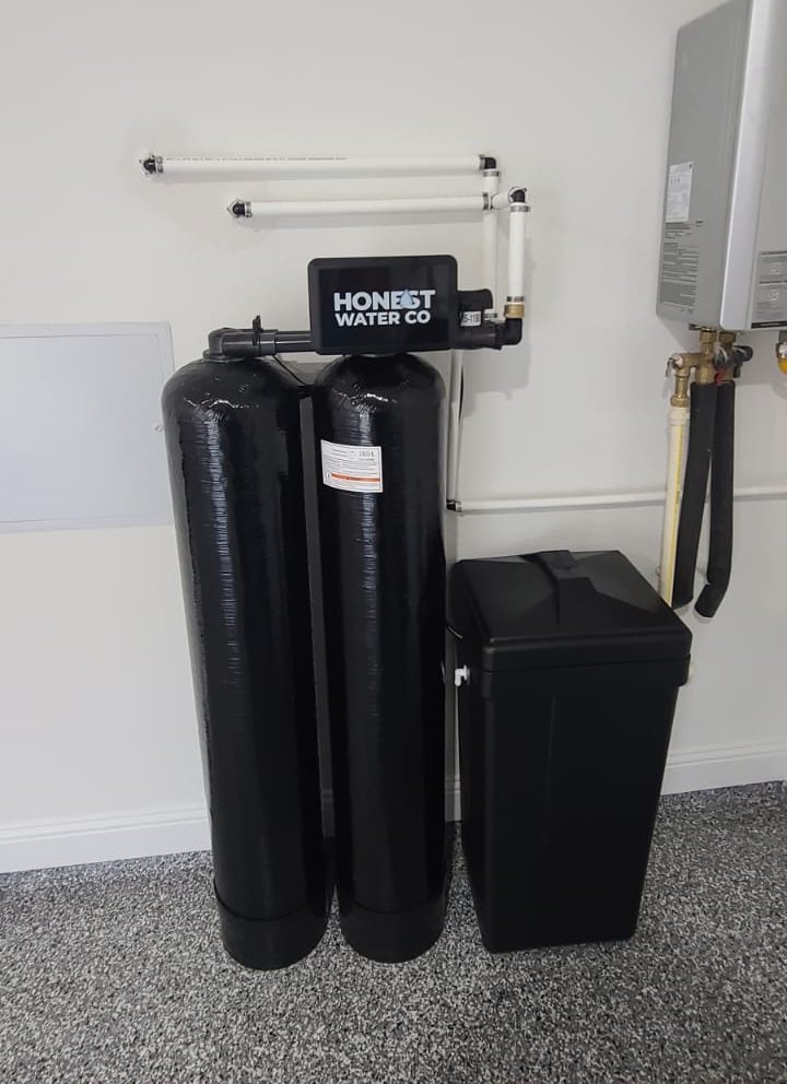 Dual tank softener and filtration system beside a tankless water heater