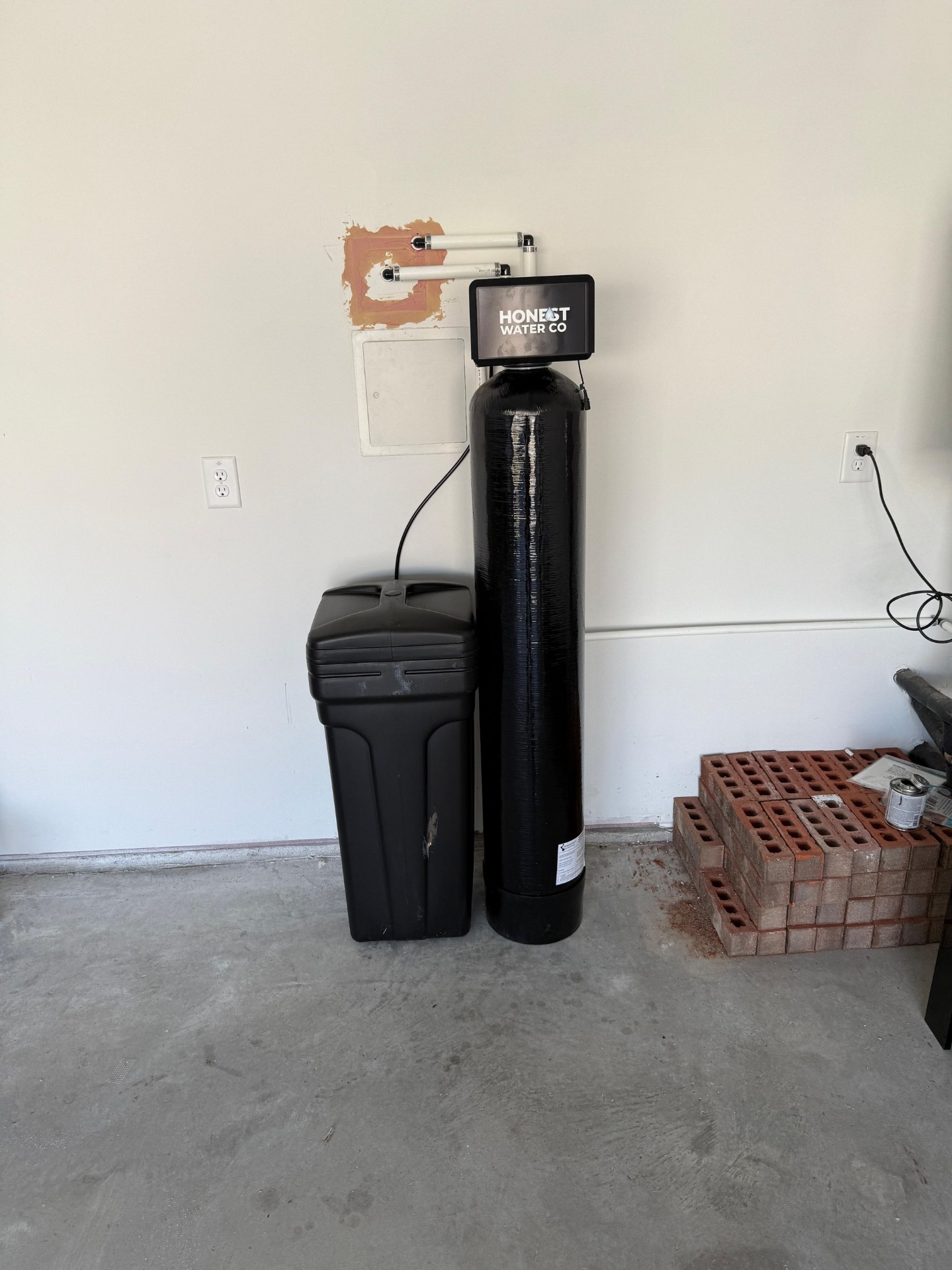 Honest Water Co whole-home softener and brine tank in a new-build garage