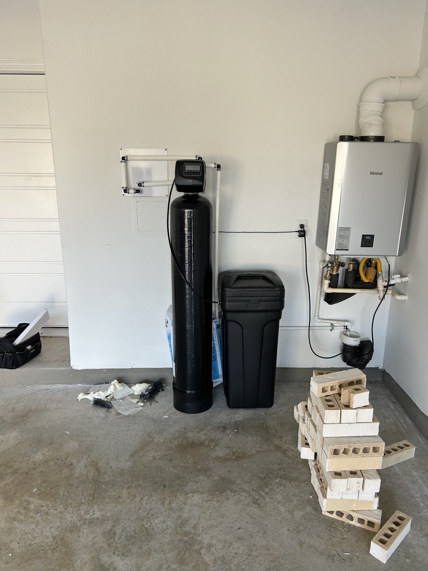 Whole-home softener installed next to a Rinnai tankless water heater