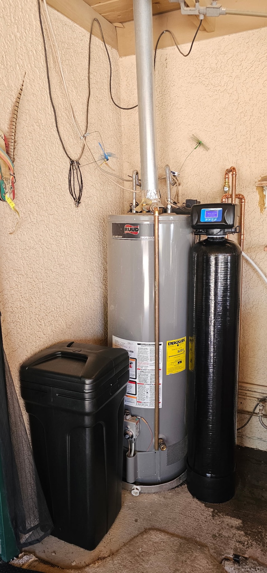 Whole-home softener with digital valve installed beside a Ruud water heater in a Tucson garage