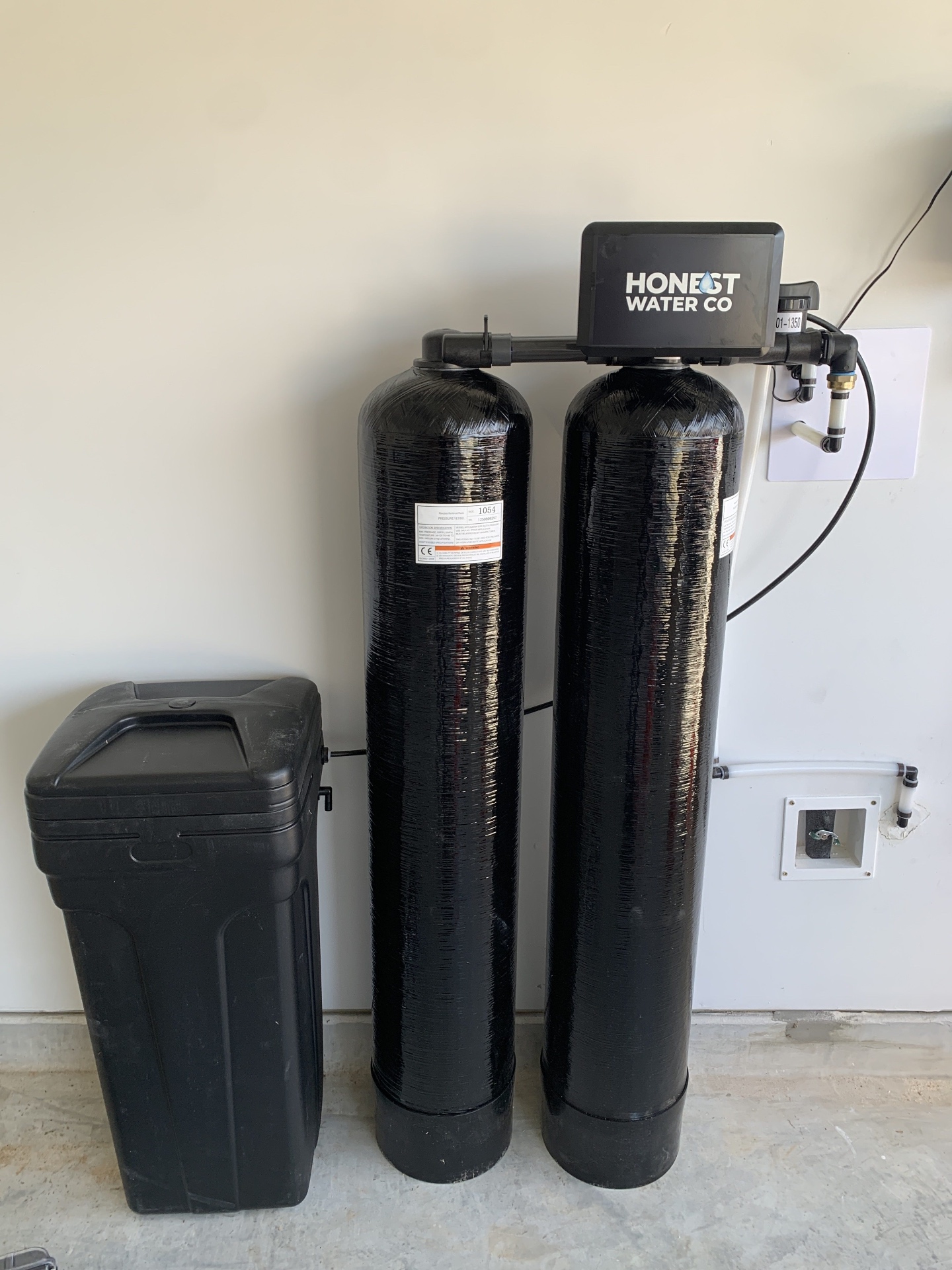 Dual tank whole-home water softener installed in a Tucson area garage